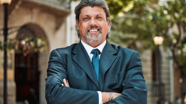 senior-man-executive-with-arms-crossed-and-smile-2025-04-06-12-43-56-utc